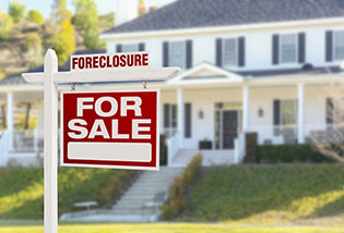foreclosure sign in front of the house